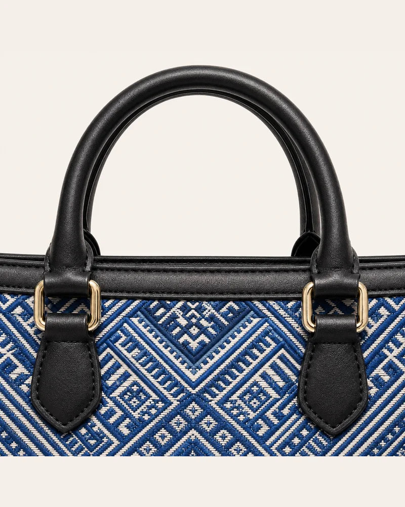 Black handles and blue Everlasting Union Motif Zhuang brocade detail