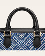 Black handles and blue Everlasting Union Motif Zhuang brocade detail