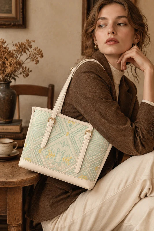 Woman styling a mint green Longevity Motif Zhuang brocade tote bag indoors