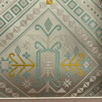 Mint green Longevity Motif woven detail on Zhuang brocade