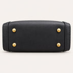 Protective feet on the black vegan leather base of the Zhuang brocade handbag