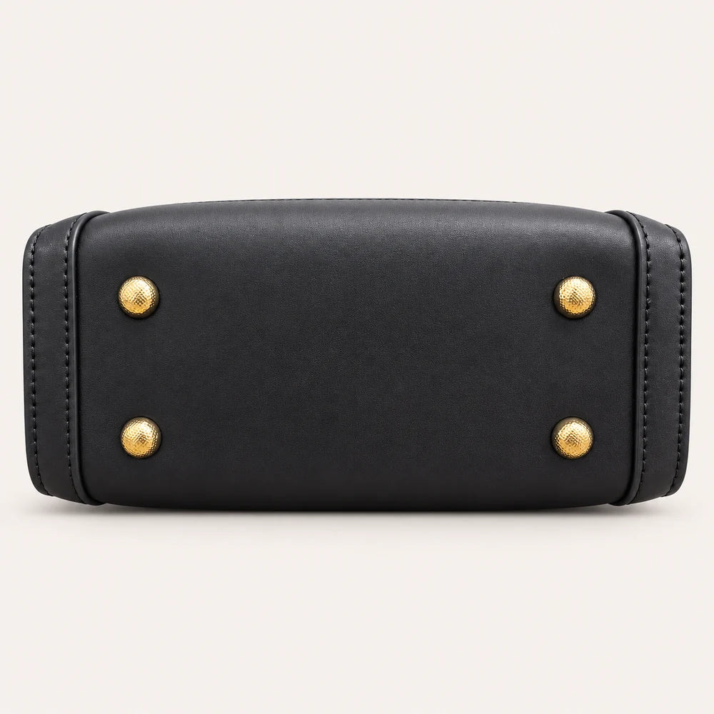 Protective feet on the black vegan leather base of the Zhuang brocade handbag