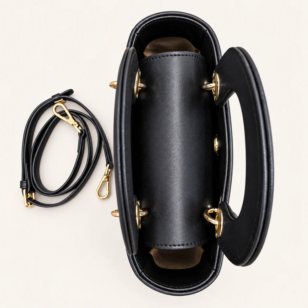 Structured black vegan leather and Zhuang brocade handbag, side view
