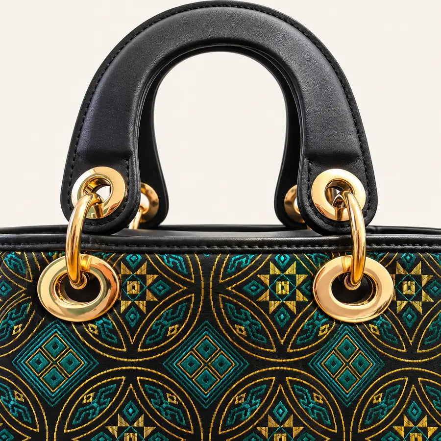 Zhuang brocade top-handle handbag with Wealth-Bringing Swallow Motif, side view