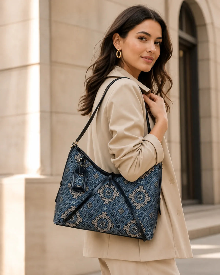 Woman carrying a navy Zhuang brocade tote bag on her shoulder