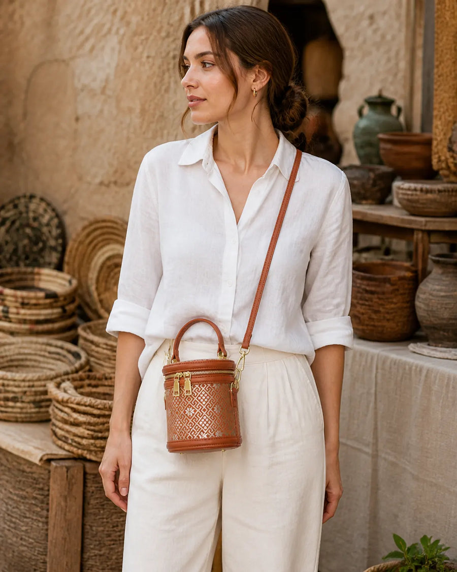 Woman wearing a terracotta Zhuang brocade bucket bag crossbody